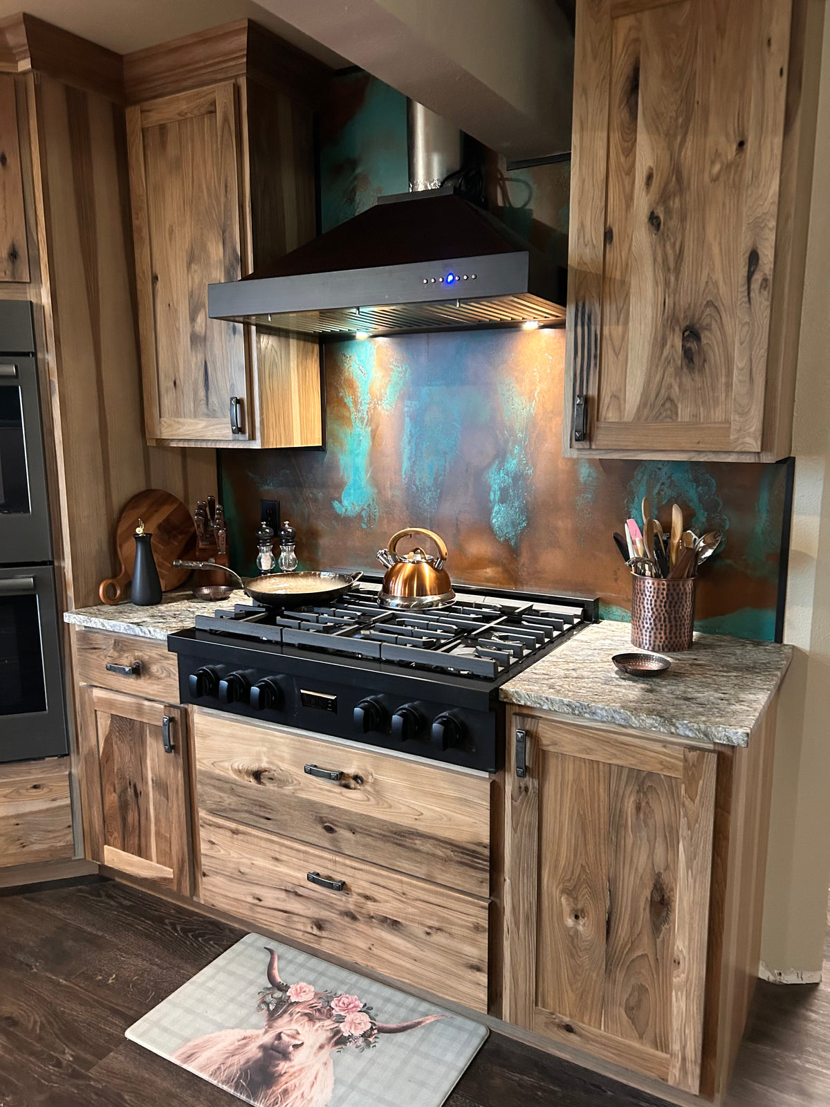 Stove backsplash covered in Tiffany Green Swirl heavy gauge patina copper