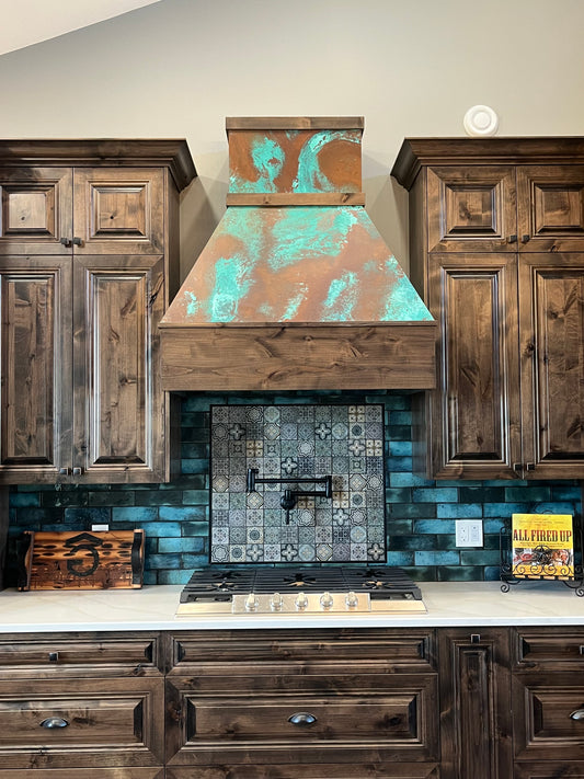Range hood covered in Tiffany Green Swirl heavy gauge patina copper