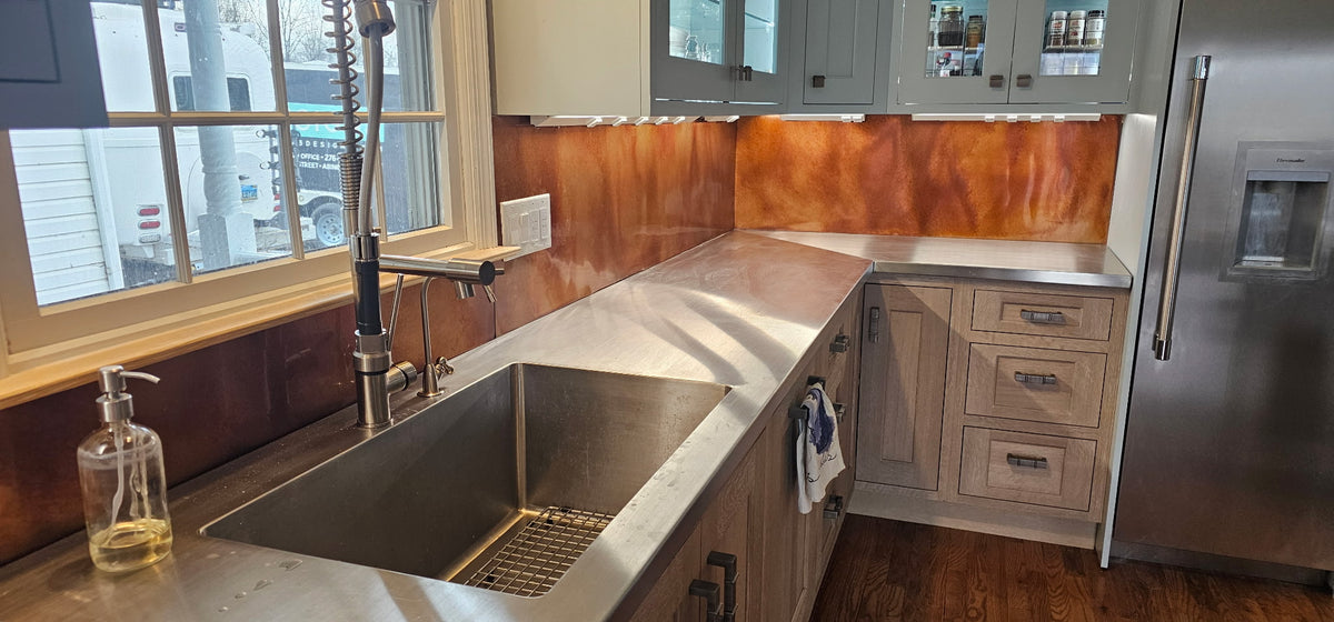 Kitchen backsplash covered in Rustic heavy gauge patina copper