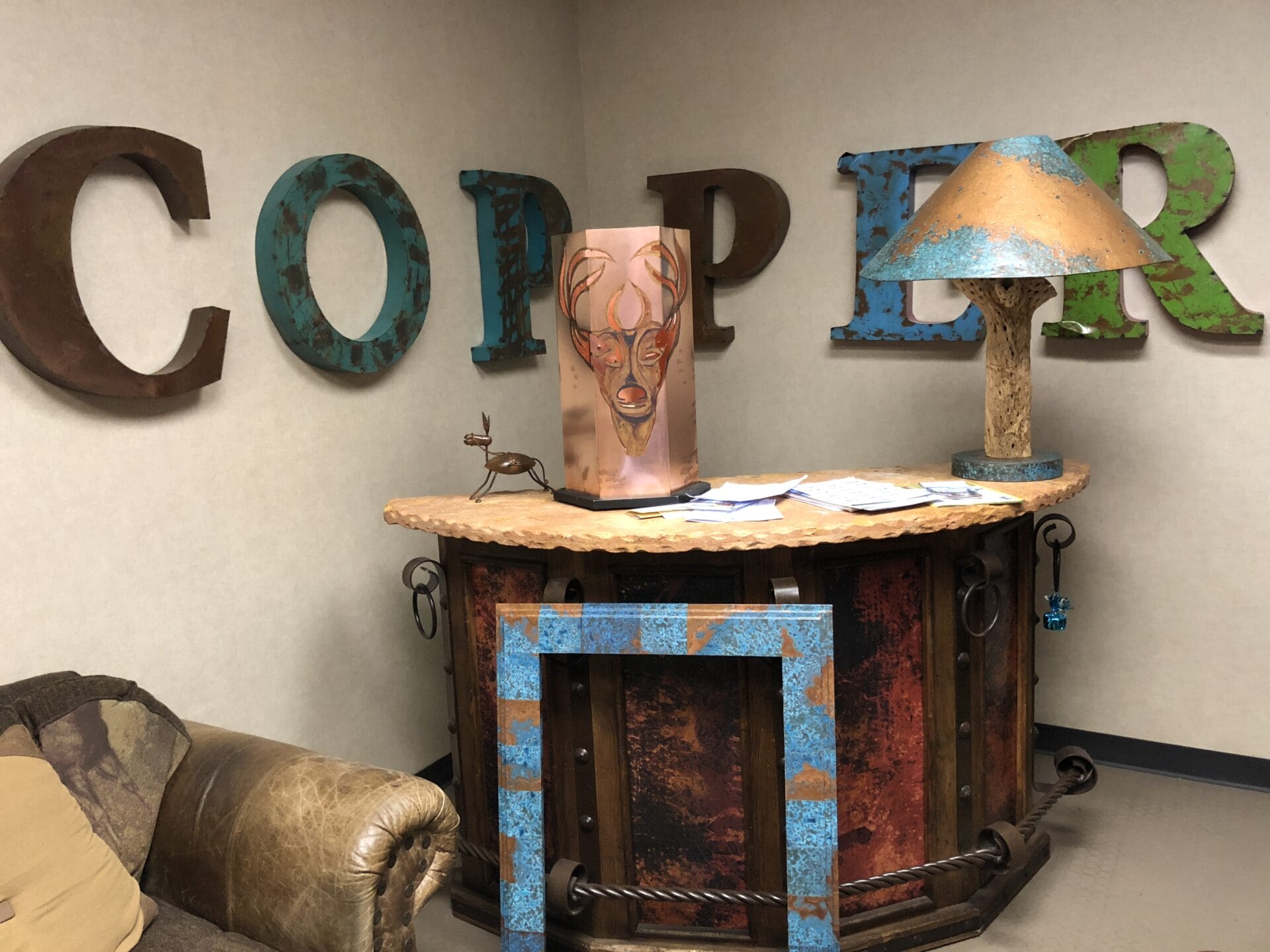 A room with a couch and chairs and a sign that says copper.